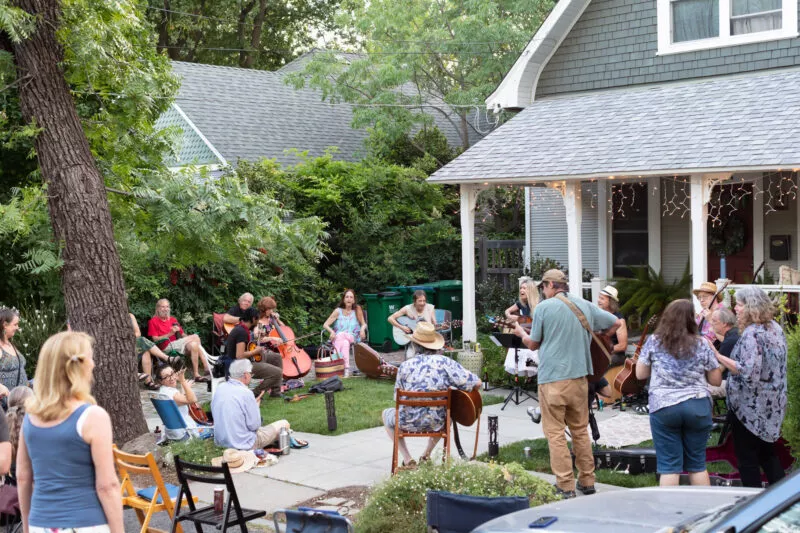 David Bilinski and Dana Hanson gather with friends in a casual acoustic performance in the front yard of this Barber neighborhood home.