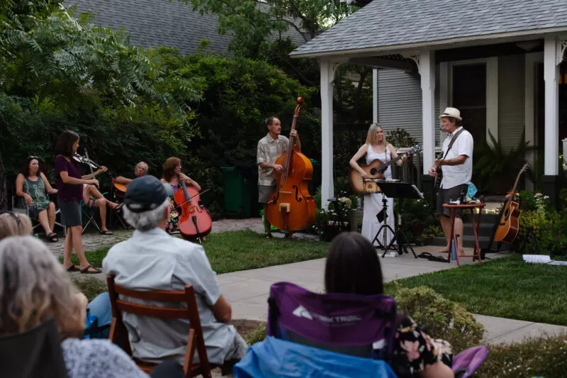 David Bilinski and Dana Hanson gather with friends in a casual acoustic performance in the front yard of this Barber neighborhood home.