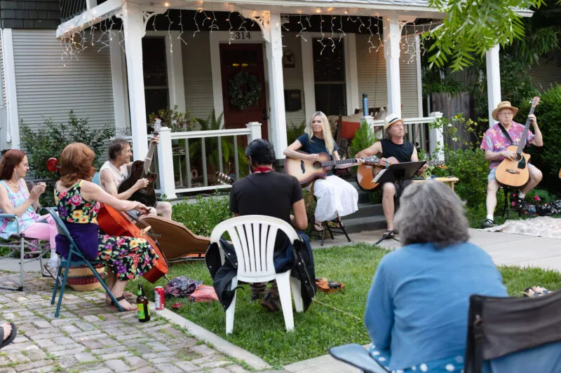 David Bilinski and Dana Hanson gather with friends in a casual acoustic performance in the front yard of this Barber neighborhood home.