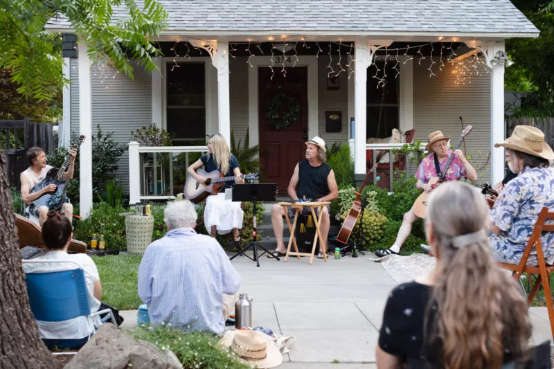 David Bilinski and Dana Hanson gather with friends in a casual acoustic performance in the front yard of this Barber neighborhood home.