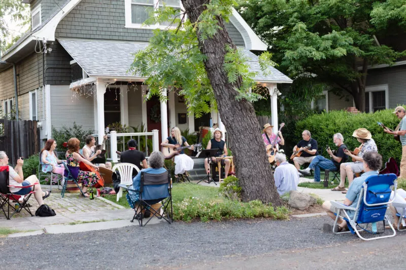 David Bilinski and Dana Hanson gather with friends in a casual acoustic performance in the front yard of this Barber neighborhood home.