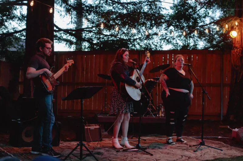 Hannah Jane Kile performing at a Listen Up backyard concert in 2022.