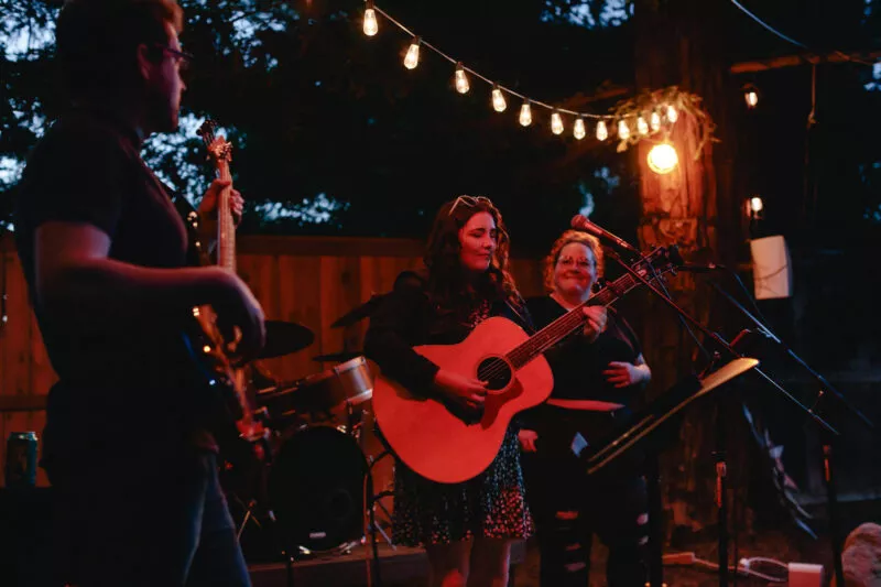 Hannah Jane Kile performing at a Listen Up backyard concert in 2022.