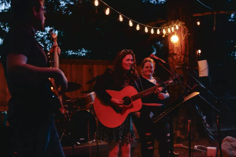 Hannah Jane Kile performing at a Listen Up backyard concert in 2022.