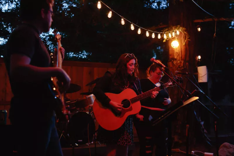 Hannah Jane Kile performing at a Listen Up backyard concert in 2022.