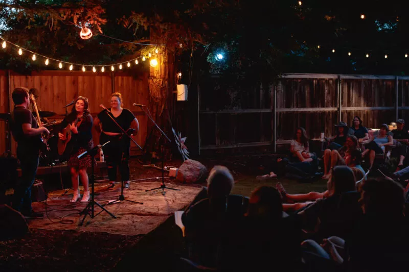 Hannah Jane Kile performing at a Listen Up backyard concert in 2022.