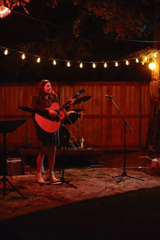 Hannah Jane Kile performing at a Listen Up backyard concert in 2022.