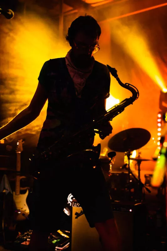 Kevin Killion, in silhouette, performs with his band, Smokey The Groove, at Lambstock 2021